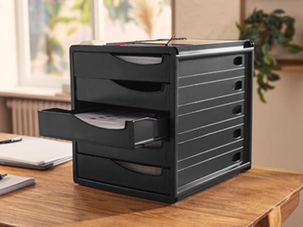 Black desk organizer with multiple drawers, one pulled out, on a wooden desk.