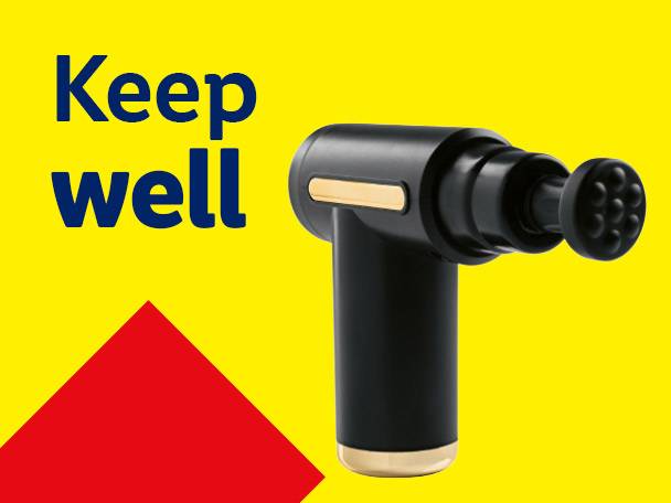 Black massage gun with gold accents on a yellow background with text 'Keep well' and a red triangle.