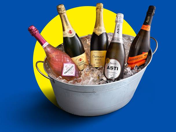Sparkling wine and rosé prosecco bottles in an ice bucket, against a yellow and blue background.