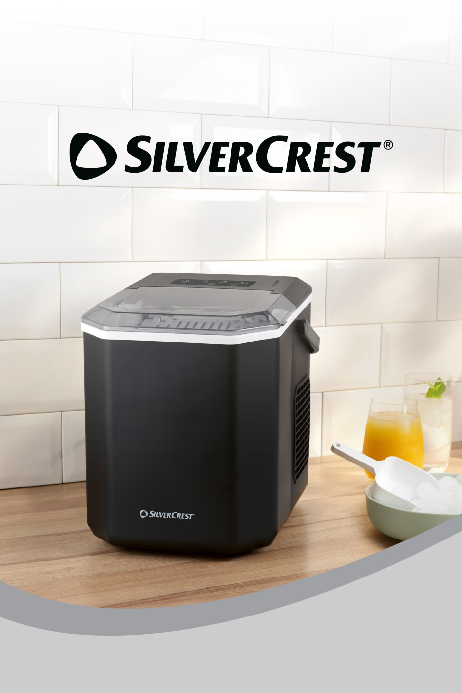 Black ice maker on a wooden counter with drinks and ice in a bowl.